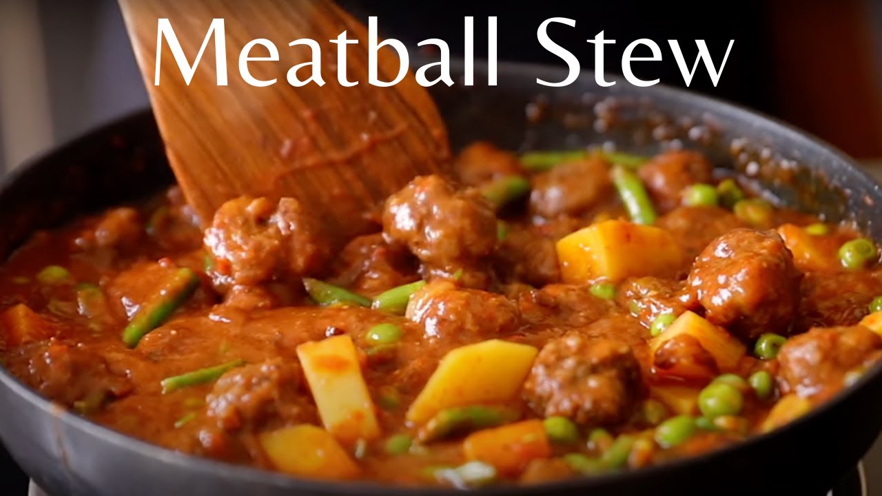 Meatballs in sauce with carrots and peas